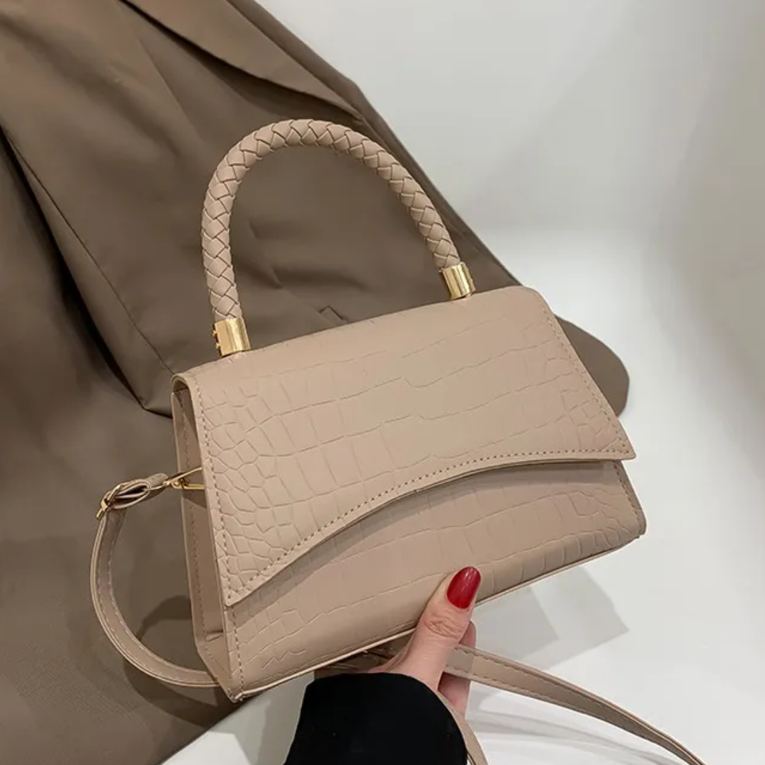 Stylish PU leather handbag featuring a top handle and a detachable crossbody strap, perfect for versatile wear and everyday use. 1