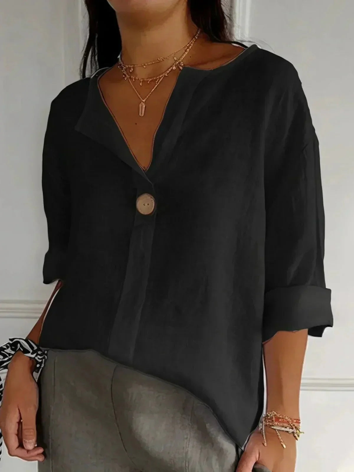 Elegant linen blouse featuring a flattering V-neckline and stylish roll tab sleeves, perfect for casual or dressy occasions. 3
