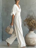 V-Neck jumpsuit for women featuring a tailored fit and luxurious silk-touch fabric, perfect for elegant occasions and stylish outings. 3