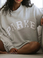 Women's oversized sweatshirt featuring soft chenille lettering, perfect for casual everyday wear and stylish comfort. 9
