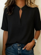 Women's relaxed fit V-neck blouse in a lightweight fabric, perfect for summer wear, featuring short sleeves and a comfortable, casual style ideal for everyday outfits. 2