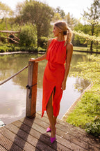 Women's slim fit midi dress featuring a sleeveless design and high neckline, perfect for summer occasions. 1