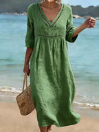 Women's summer V-neck cotton dress featuring a flowy casual style and convenient side pockets, perfect for warm weather outings. 0