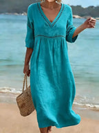 Women's summer V-neck cotton dress featuring a flowy casual style and convenient side pockets, perfect for warm weather outings. 3